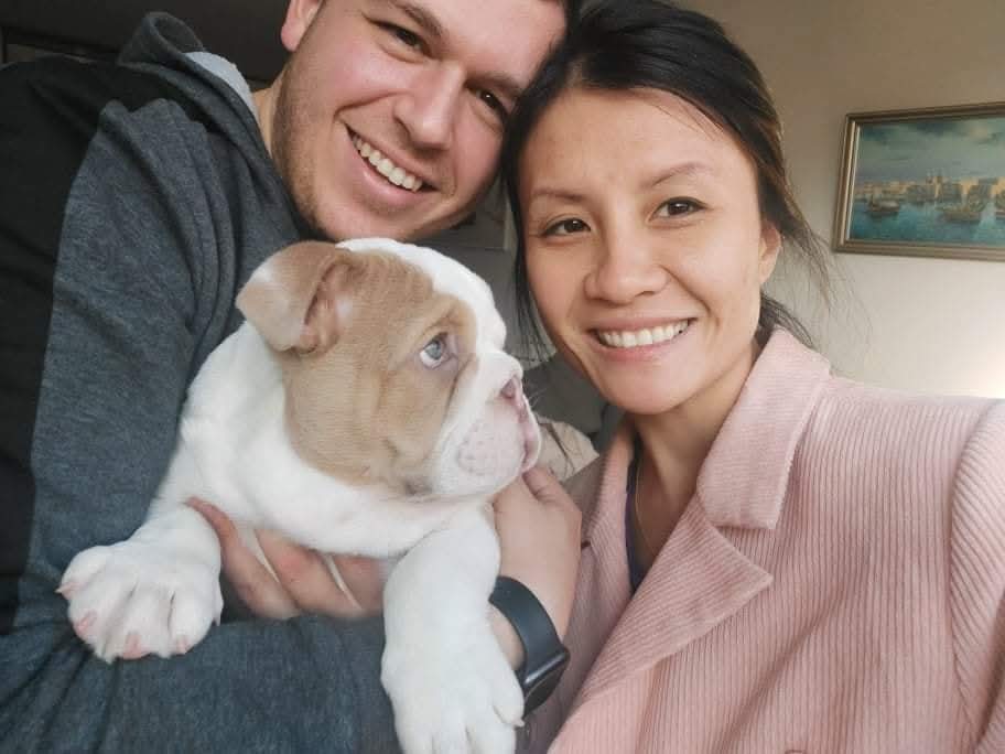 Family selfie with bulldog puppy